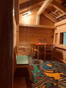 a dining room with a table and chairs and a rug at Herbst Alm in Unken