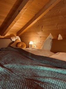 a bedroom with a bed in a wooden ceiling at Herbst Alm in Unken
