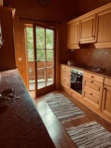 a kitchen with wooden cabinets and a stove top oven at Herbst Alm in Unken +23 photos