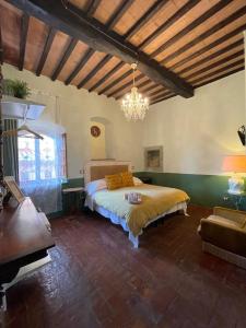 a bedroom with a large bed and a large window at Osteria Del Vicario in Certaldo