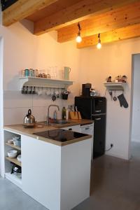 a white kitchen with a sink and a stove at Pod Beskydem, Velké Karlovice in Velké Karlovice