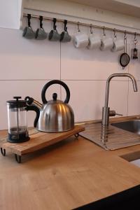 a tea kettle on a cutting board on a kitchen counter at Pod Beskydem, Velké Karlovice in Velké Karlovice