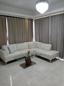 a living room with a couch and a coffee table at AMG Suites Apartment in Santo Domingo