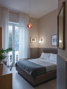 a bedroom with a bed and a large window at Maison boutique Matteotti in Matera