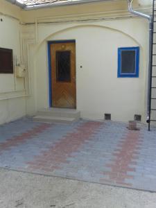 a room with a door and a brick floor at Elefánt Apartment in Keszthely