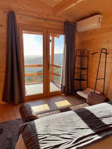 a bedroom with a bed and a large window at Quinta Altamira in Portalegre