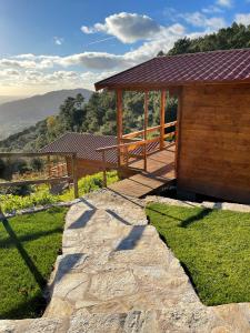 a wooden pavilion with a stone walkway next to at Quinta Altamira in Portalegre