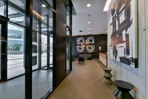 a corridor in a building with a lobby with windows at Luxury skyline condo in downtown FREE 24/7 parking in Winnipeg