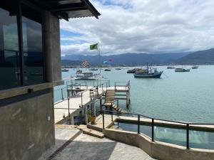 a view of a dock with boats in the water at 1819 Marine Hotel in Ubatuba