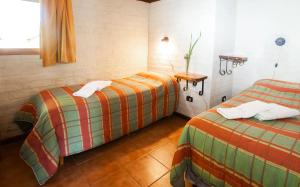 מיטה או מיטות בחדר ב-Complejo Nueva Era