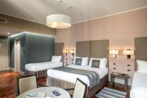 A bed or beds in a room at Monti Palace Hotel