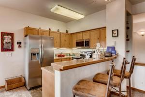 a kitchen with stainless steel appliances and wooden cabinets at Breckenridge Luxury Condo, Easy Access to Ski Lifts! in Breckenridge