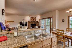 a kitchen with a sink and a fireplace at Breckenridge Luxury Condo, Easy Access to Ski Lifts! in Breckenridge