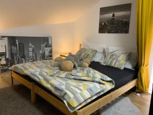 a bedroom with a bed with a stuffed animal on it at Apartmány Tylovice in Rožnov pod Radhoštěm