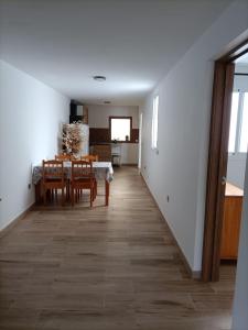 a dining room and kitchen with a table and chairs at Apartment Taliarte 36 in Vecindario