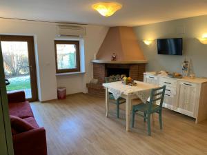 a living room with a table and a fireplace at La Casetta Bosco in Bosco Chiesanuova