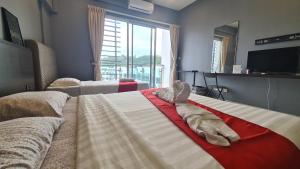 a bedroom with a large bed with a large window at Aeropod KK Studio Unit 09 Near Airport And City Free Parking in Kota Kinabalu