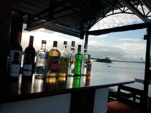 a group of bottles of alcohol sitting on a table at Hotel La Union in Flores