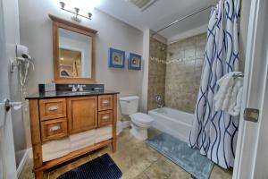 a bathroom with a sink and a toilet and a tub at PierPark 2BR Beachfront Luxury Condo w View Sterling Breeze Resorts in Panama City Beach