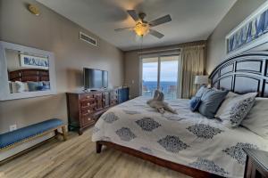 a bedroom with a bed with a stuffed animal on it at PierPark 2BR Beachfront Luxury Condo w View Sterling Breeze Resorts in Panama City Beach +45 photos