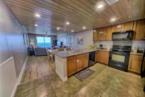 a kitchen with a sink and a stove top oven at Sterling Breeze - Luxury Beach Front Condo in Panama City Beach