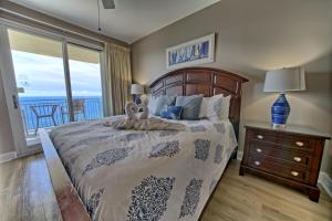 a bedroom with a bed with a view of the ocean at PierPark 2BR Beachfront Luxury Condo w View Sterling Breeze Resorts in Panama City Beach