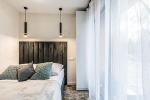 Postel nebo postele na pokoji v ubytování Aparthome Tatra