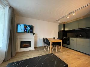a living room with a table and a fireplace at Appart centre station les 2 Alpes, parking, wifi in Les Deux Alpes