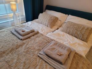Una cama con toallas y almohadas encima. en Apartament Warszawska 26 - Klimatyzacja, en Gorzów Wielkopolski