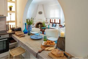 a kitchen and living room with a table with food on it at Villa Eleni Paxos in Gaios +22 photos