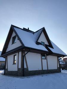a house with snow on the roof at Domek Góralski Kąty na Wierchu in Szaflary