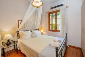 a bedroom with a bed and a window at Villa Eleni Paxos in Gaios