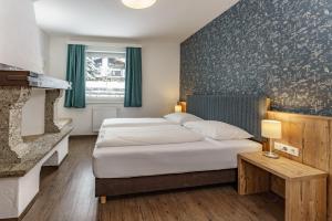a hotel room with a bed and a fireplace at Appartements Landhaus Hubertus in Schladming