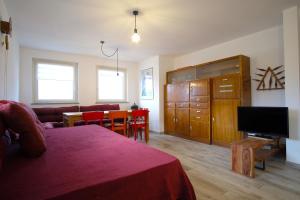 a living room with a bed and a dining room at Sérémont 534 in Charvensod