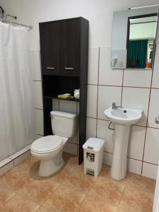 a bathroom with a toilet and a sink at Banana Bay Marina in Golfito