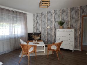 a living room with a table and chairs and a dresser at Einhaus in Möttau