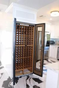 a kitchen with a wine cellar with a refrigerator at Quiet Mountain Vineyard Above the Clouds in Malibu