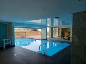 a swimming pool in a house with a glass ceiling at Victoria Appartement in Menton