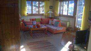 a living room with a couch and a coffee table at Müllershus in Langwies