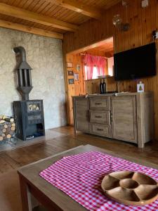 a living room with a table and a stove at Chalet Hill Zabljak in Žabljak