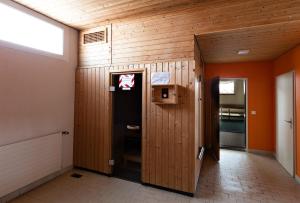 a locker room with wood paneled walls and a door at Charming Studio facing Piz Rosatsch in St. Moritz