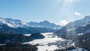 a view of a snowy mountain range with a ski resort at Charming Studio facing Piz Rosatsch in St. Moritz