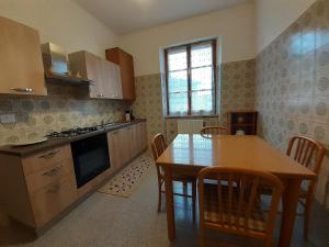 a kitchen with a wooden table and a dining room at Casa Olga in Pianella