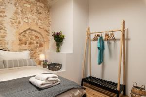een slaapkamer met een bed en een stenen muur bij Beit Petra in Daratso
