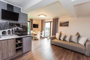 a living room with a couch and a table at Apartamenty Dawna Wisła in Wisła