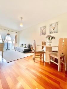 a living room with a table and a couch at University of Minho- INL Campus Gualtar Apartment 2 in Braga