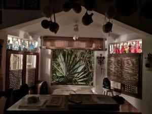 a room with two windows and a desk and a table at Casa del Arquitecto in Cancún