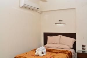 a bedroom with a bed with a stuffed animal on it at ASWAN NILE PALACE (swimming pool-rooftop-Nile view) in Aswan