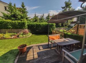 a patio with a table and an umbrella at Ferienwohnung Cologne in Cologne