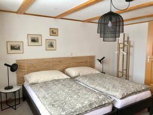 a bedroom with a bed with a wooden headboard at Chalet Pironnet with BEST Views, Charm and Comfort! in Lauterbrunnen